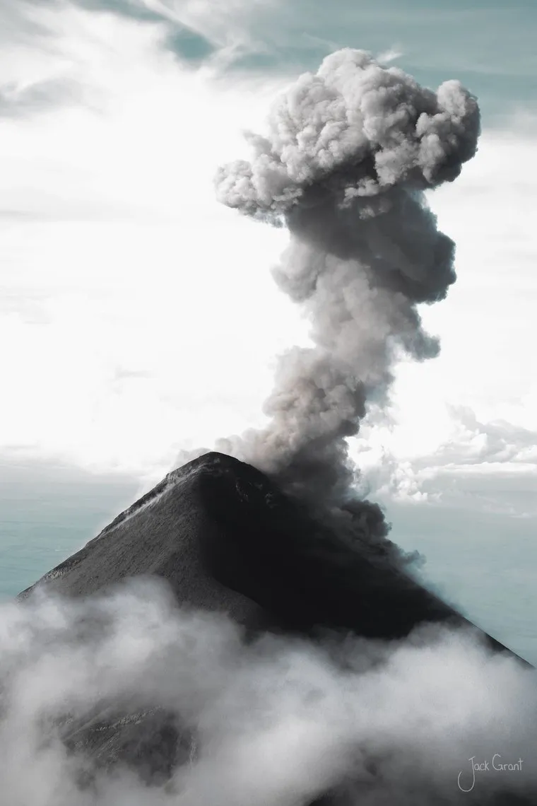 Volcano erupting a column of ash above the cloud line, Guatemala